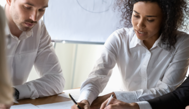 group of business people reviewing earnings documents