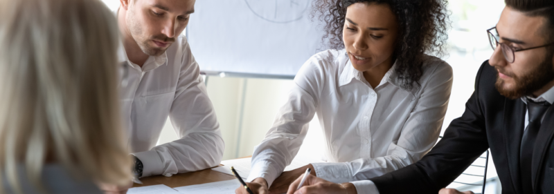 group of business people reviewing earnings documents