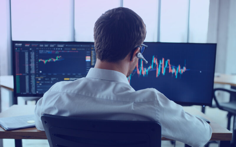 Man reviewing investor sector insights on his laptop
