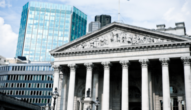 a building with columns and a flag on top