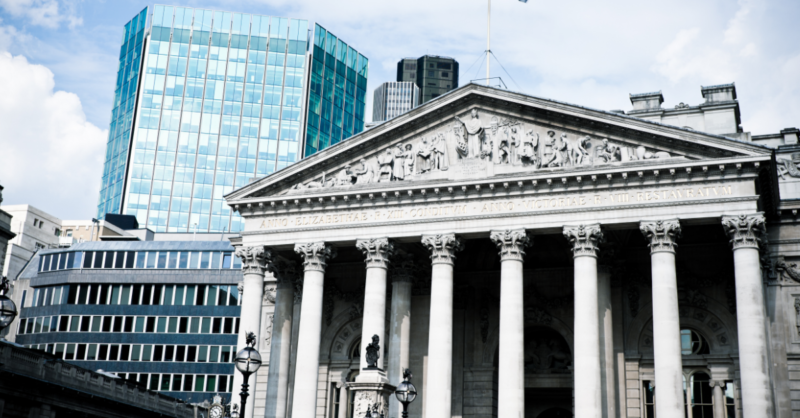 a building with columns and a flag on top