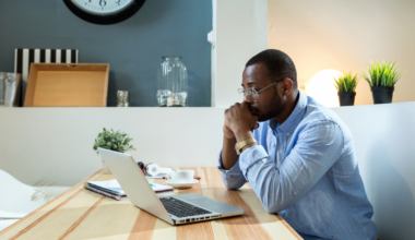 a man sitting at a table with a laptop