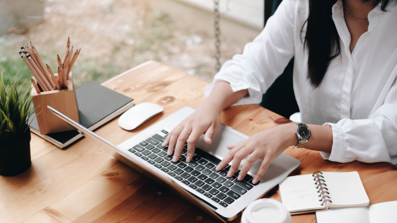 a person typing on a laptop